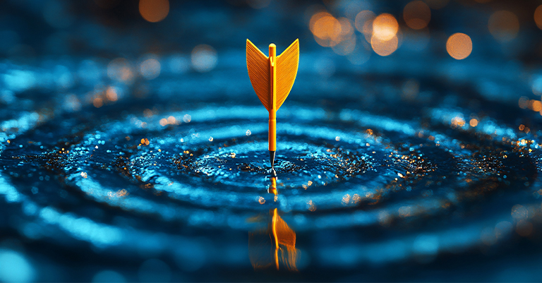 TeamPerform_5 • Roche Leadership Golden dart standing upright in the center of blue rippling water, symbolizing precision, focus, and achieving goals with accuracy.